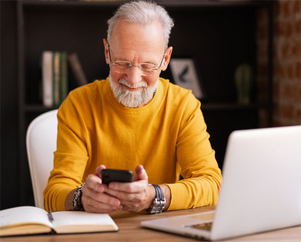 guy using a phone and smiling, he could be browsing your website